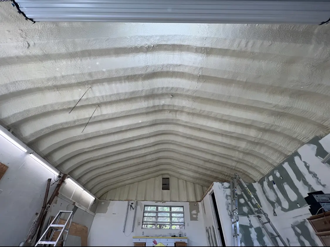 Spray polyurethane foam applied to the underside of a metal roof deck in Pine